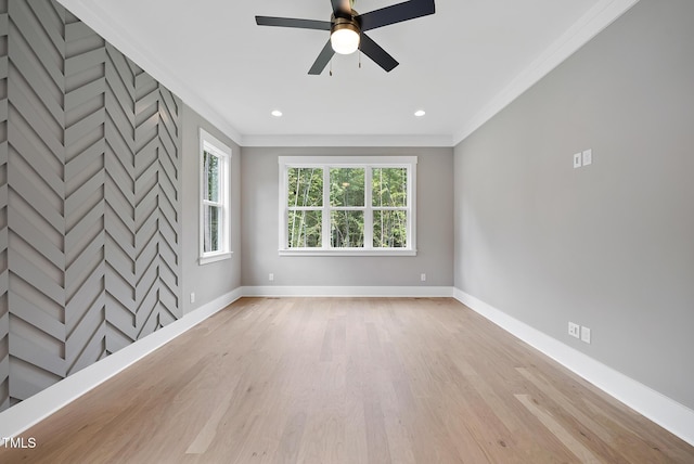 empty room featuring recessed lighting, light wood-type flooring, baseboards, and crown molding