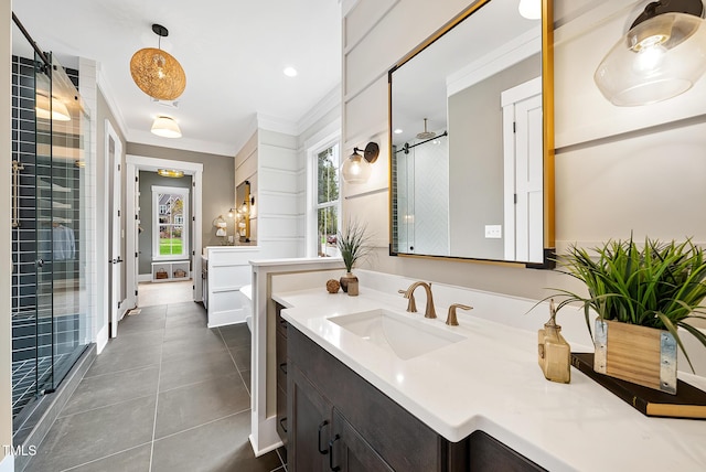 full bathroom featuring tile patterned floors, vanity, a stall shower, and crown molding