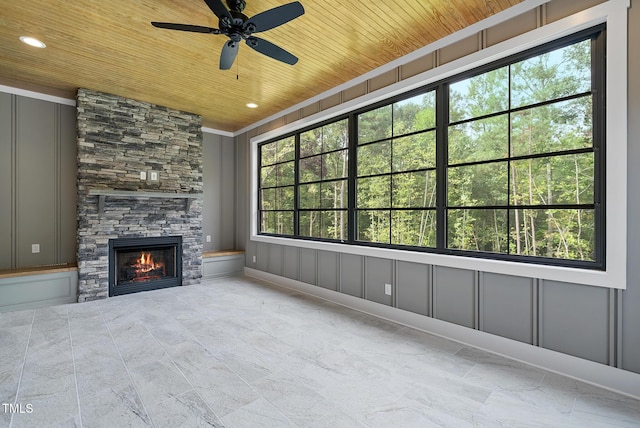 unfurnished living room featuring a decorative wall, recessed lighting, a fireplace, and wood ceiling