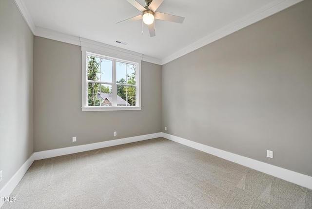 carpeted spare room featuring baseboards, visible vents, and ornamental molding