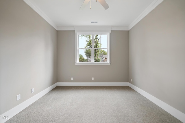 carpeted spare room featuring visible vents, baseboards, and ornamental molding