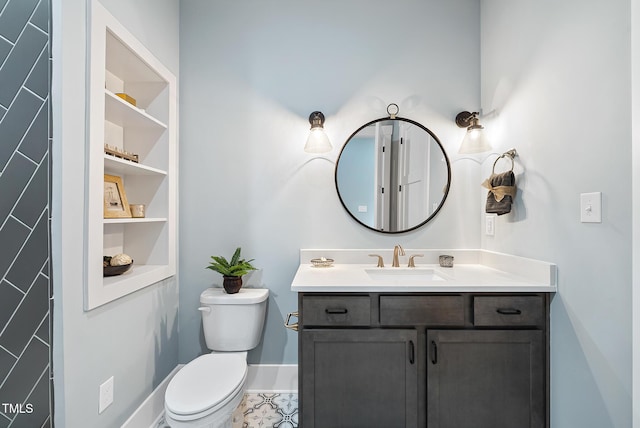 half bathroom featuring vanity, toilet, and baseboards