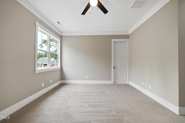 carpeted empty room with crown molding, baseboards, and visible vents