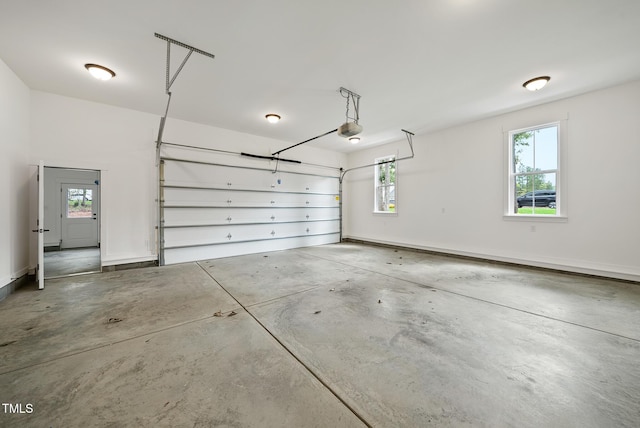 garage with baseboards and a garage door opener