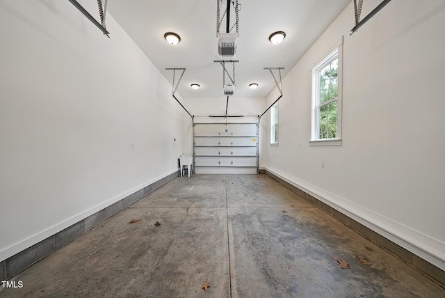 garage with a garage door opener and baseboards