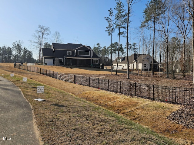 view of yard with an attached garage and fence