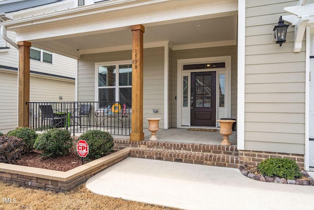 view of exterior entry featuring a porch