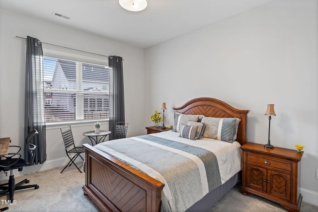 bedroom featuring visible vents, light carpet, and baseboards