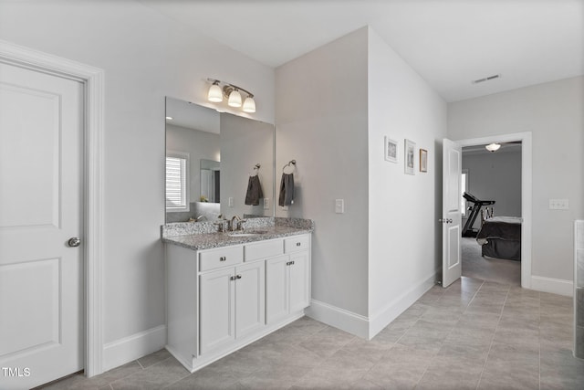 bathroom with visible vents, baseboards, and vanity