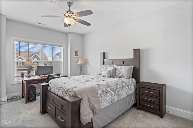 bedroom featuring visible vents, baseboards, light colored carpet, and a ceiling fan