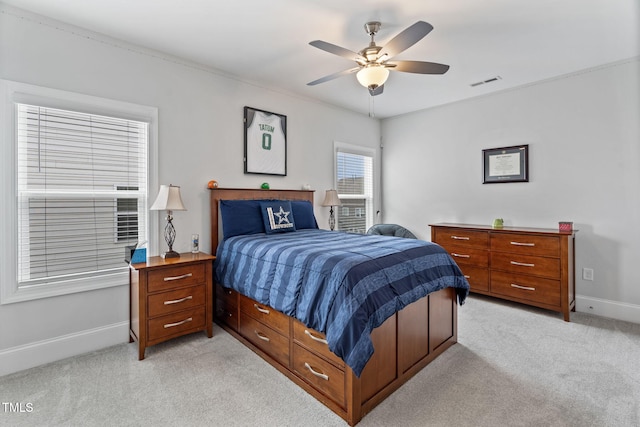 bedroom featuring light carpet, visible vents, a ceiling fan, and baseboards