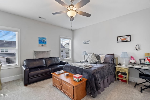 bedroom featuring ceiling fan, baseboards, visible vents, and light carpet