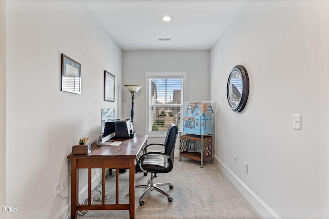 carpeted office featuring visible vents and baseboards