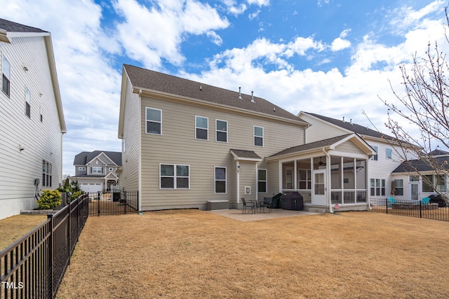 rear view of property featuring a patio, a lawn, a fenced backyard, and a sunroom