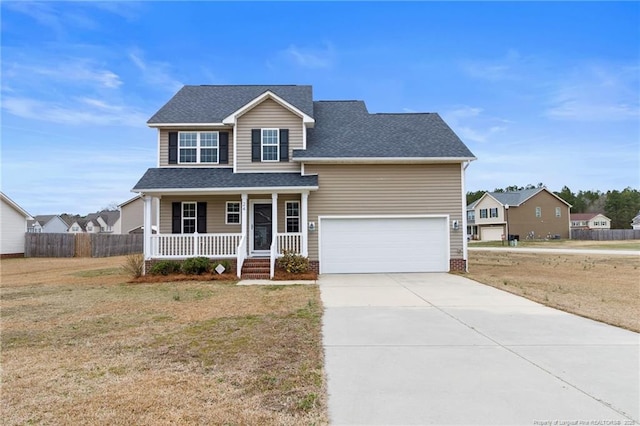 traditional-style house featuring a porch, a garage, fence, driveway, and a front lawn