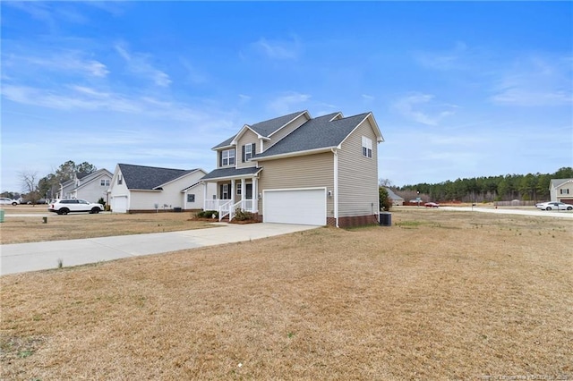 traditional-style home featuring a garage, a front yard, driveway, and central AC unit