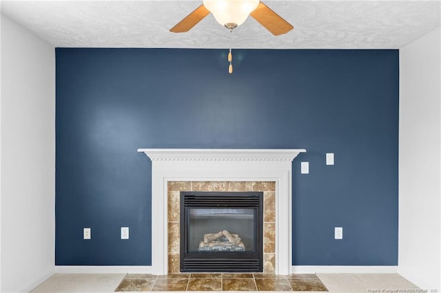 room details with a textured ceiling, a tile fireplace, and baseboards