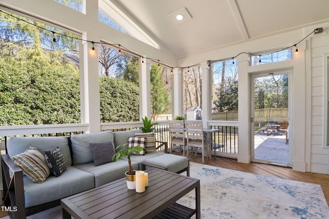 sunroom featuring lofted ceiling