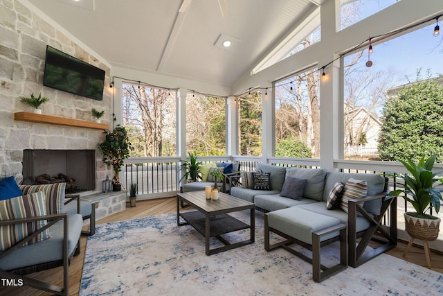 sunroom / solarium with lofted ceiling and a fireplace