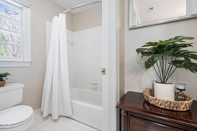 bathroom with visible vents, shower / bath combo with shower curtain, toilet, and tile patterned flooring