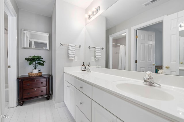 full bath featuring double vanity, visible vents, tile patterned flooring, and a sink