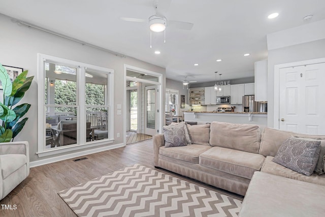 living room with visible vents, wood finished floors, recessed lighting, baseboards, and ceiling fan