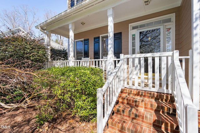 view of exterior entry with covered porch