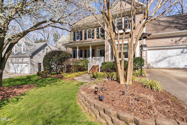 view of front of home featuring a front lawn, a porch, and driveway