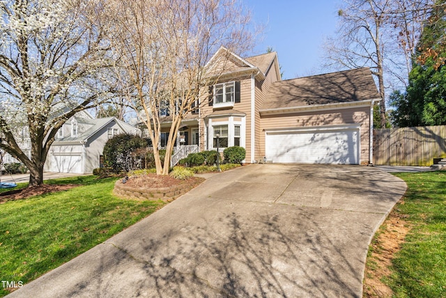 view of front facade featuring an attached garage, driveway, a front lawn, and fence