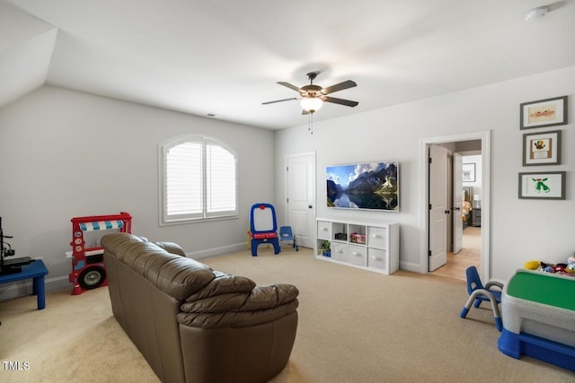 living room featuring lofted ceiling, a ceiling fan, baseboards, and carpet floors