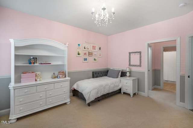 bedroom with baseboards, light carpet, and an inviting chandelier