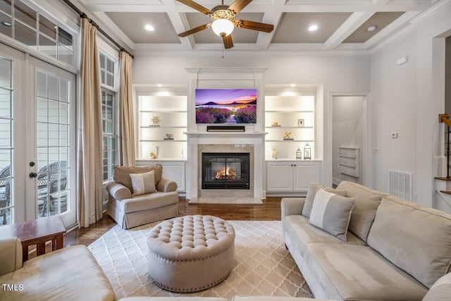 living room with visible vents, coffered ceiling, a fireplace, ornamental molding, and french doors