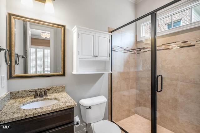 full bath featuring toilet, a stall shower, and vanity