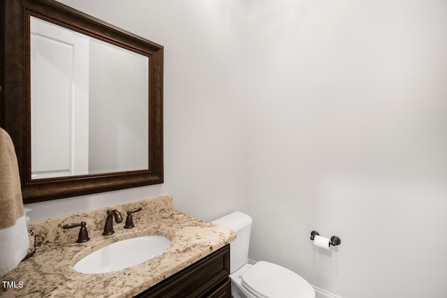 bathroom with toilet and vanity