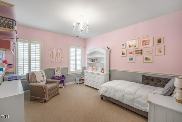 bedroom featuring a notable chandelier, multiple windows, baseboards, and carpet floors