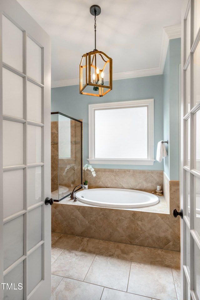 full bath with a garden tub, a notable chandelier, and ornamental molding