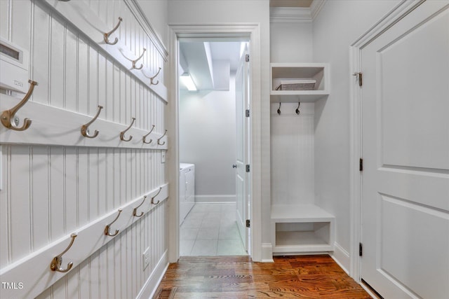 mudroom featuring baseboards, washer / clothes dryer, and wood finished floors