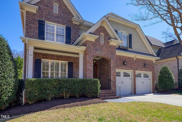 traditional-style home featuring brick siding, driveway, and a standing seam roof