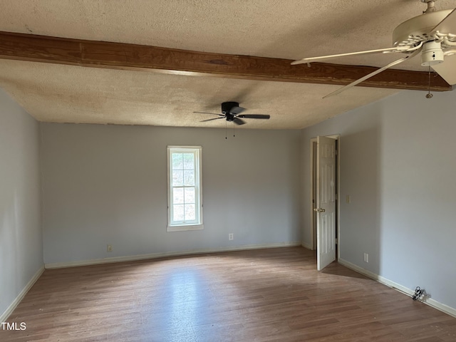 unfurnished room with a ceiling fan, a textured ceiling, and wood finished floors