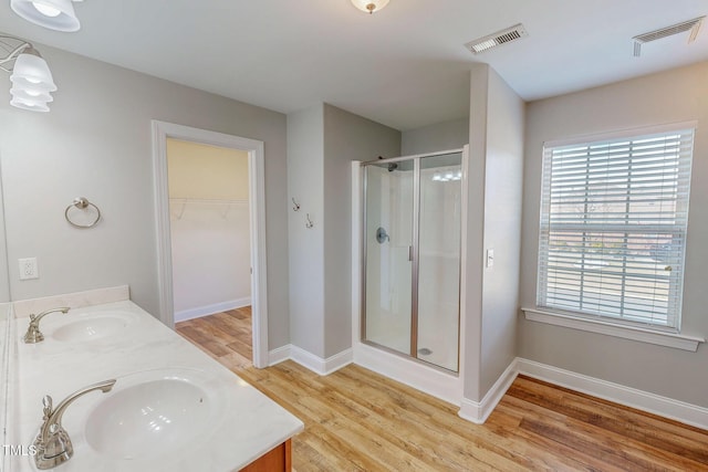 bathroom featuring a sink, visible vents, and a shower stall