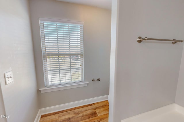 bathroom featuring wood finished floors and baseboards