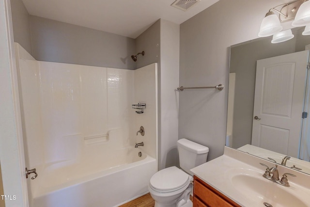 bathroom featuring shower / bathing tub combination, visible vents, toilet, and vanity