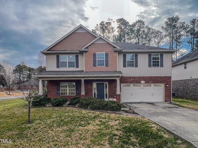 craftsman house with driveway, brick siding, an attached garage, and a front lawn