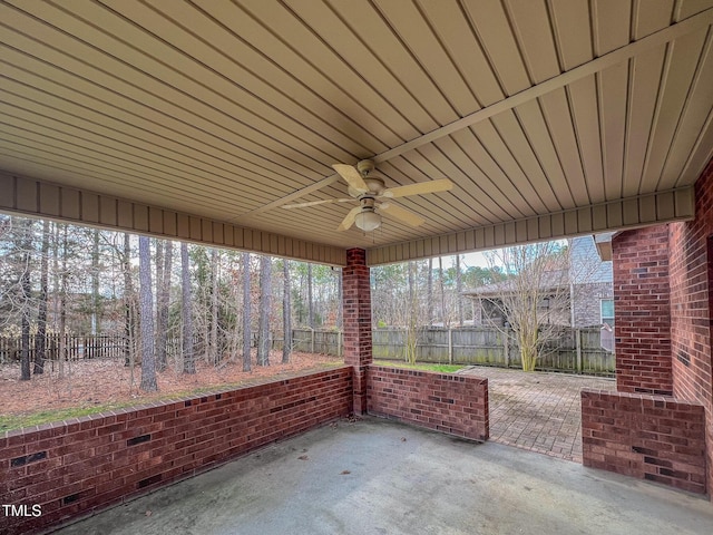 view of patio featuring ceiling fan and fence