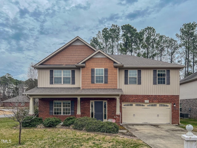 craftsman-style home with a garage, brick siding, central AC unit, and driveway