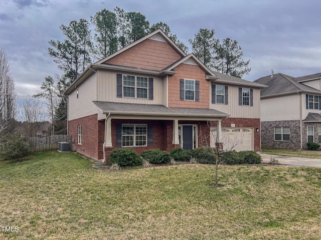 craftsman-style house with a front lawn, driveway, fence, a garage, and brick siding