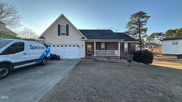 view of front of property featuring an attached garage, brick siding, a porch, and driveway