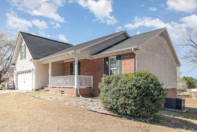 view of side of property featuring central air condition unit, covered porch, concrete driveway, and a shingled roof