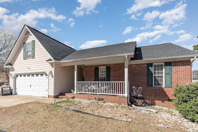 view of front facade with brick siding, a shingled roof, a porch, a garage, and driveway