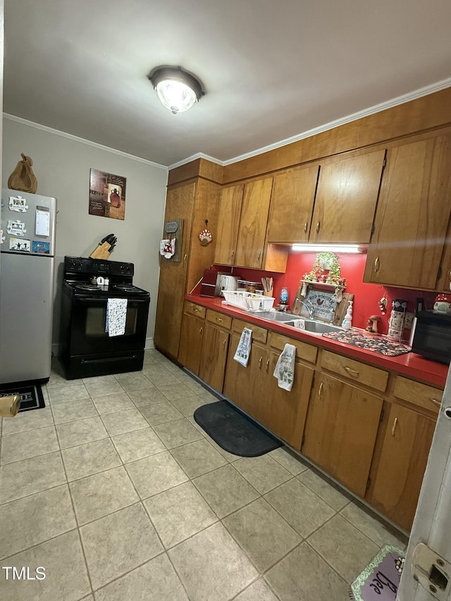 kitchen with brown cabinets, black appliances, light tile patterned flooring, and crown molding